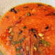 Add the spice paste to the frying mixture. Mix well. Bring the mixture to a boil over high heat.