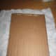 I glued the two pieces of cardboard together by hot gluing down the edges. I didn't want to glue in the middle because it would make it difficult to put in pushpins. After, that I cut fabric to cover the cardboard.