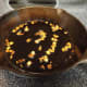 Once the oil is hot, gently add 4 minced gloves of garlic. As you can see, I like my garlic nice and toasty!