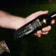 Apply a few sprays of brake cleaner or rub acetone on the bottle. Use the metal scraper to remove the label.