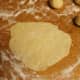Use a rolling pin (or wine bottle) to roll out each ball to create the discs for the empanadas.