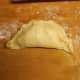 Seal the empanadas by rolling the edges over. You can also use a fork to press the sides together if you prefer.
