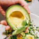 Scoop the avocado with a large spoon and add it to the mixture.