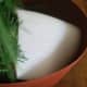 Cut a small piece of thin packing Styrofoam to cover up the inside of your pot. You can also use a piece of white fleece.
