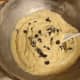 Fold in the chocolate chips with a large mixing spoon until they're well combined with the batter.