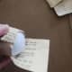 On one side, cut two slits into the paper. Trim off the top section, leaving the bottom. Apply Modge Podge to the paper and the ball, and then gently fold the paper up to cover the ball. Repeat on the other side.
