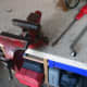 Unscrewing the bolts to relocate the metal vice.