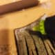 Spread two thin lines of hot glue on the top edge, back of your bristles, to secure them to your handle.
