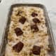Sprinkle the hazelnuts on top of the ice cream before freezing.