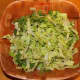 Thinly slice 8 cups of romaine lettuce and place it into a large salad bowl.