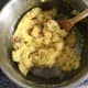Mustard and chilli are stirred in to mash