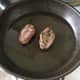 Pigeon breasts are turned to fry on second side.