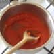 Sweet pepper and tomato sauce is seasoned and heated