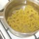 Fusilli pasta is added to boiling, salted water
