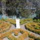 Frist, swing open the green metal gate and there is a topiary garden.