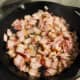 Put bacon in heated skillet. Cover and cook over medium heat.