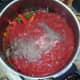Tomatoes are added to pot with peppers and pheasant
