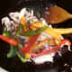 Peppers are added to part cooked pheasant
