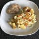 Stir fried potato is plated with pheasant breast