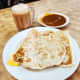 Roti prata is one of the most beloved breakfasts in Singapore, always eaten with a small bowl of curry for dipping too. This Indian flatbread dish is quite a culinary institution too. You can have yours “plain,” with egg, with onion, etc.