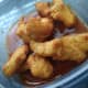 Dip the chicken nuggets in the sauce