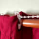 Clips, attached to each grommet, are separated by a length of beads.