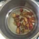 Chopped plums are put on to stew