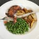 Enjoying wild goose and plum sauce with wedges and peas