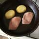 Cooled potato slices and bacon medallions are fried in goose breast juices