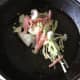 Cabbage, bacon and onion added to goose frying juices in pan