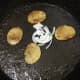 Onions are added to fry with almost ready potato slices