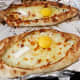 Adjarian khachapuri, open bread stuffed with cheese and egg yolk.