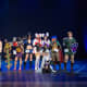 A group of cosplayers on stage at Yukicon 2014 convention in Finland.