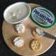 Cream cheese is spread on crackers