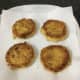 Fried eggy bread is lifted to kitchen paper covered plate