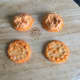 Red pepper hummus is spread on rice crackers