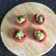 Guacamole is spooned in to tomato halves