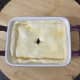 Puff pastry is laid on pigeon chilli mix and glazed