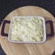 Mashed potato is smoothed over pigeon pie filling
