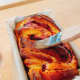 Brush the babka with the sugar syrup to glaze the top and allow some of the syrup to be absorbed by the babka.