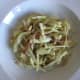 Stir fried cabbage, bacon and onion is plated
