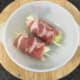 Cabbage rolled in bacon is laid in casserole dish