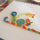 Arrange the coils and huskings to form a design.