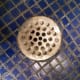 Shower Drain. Unscrew the screws holding it in place first. Be careful not to let screws go down the drain.