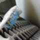 Using a toothbrush to clean the radiator.