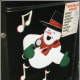 A singing snowman painted at the bottom of a door panel.