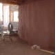 Mud application to rammed earth tire walls.