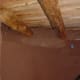 Mud application to rammed earth tire walls.