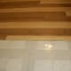 No trim; the tile floor was previously raised and required only careful cutting to match.