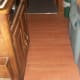 RV kitchenette floor with no trim on the sides, carpet trim on the ends of the area